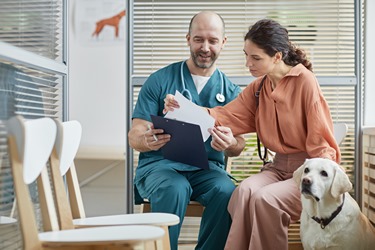 Young Woman Consulting with Dog