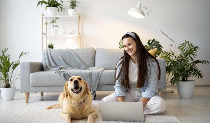 woman in home with their ESA dog working
