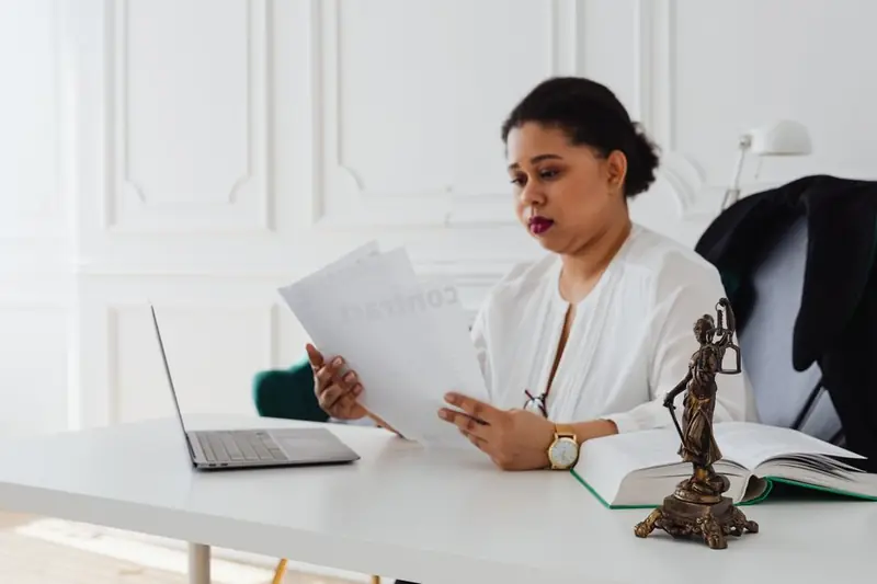 Person reading legal document on laptop
